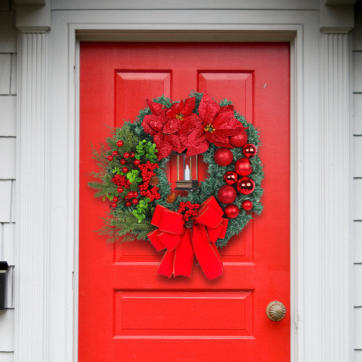 Christmas wreath with decorative lantern and red flowers