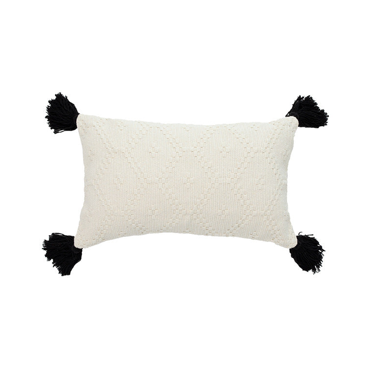 Decorative cushion cover made of woven cotton blend with tactile diamond structure and contrast tassels
