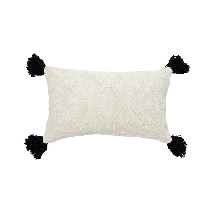 Decorative cushion cover made of woven cotton blend with tactile diamond structure and contrast tassels