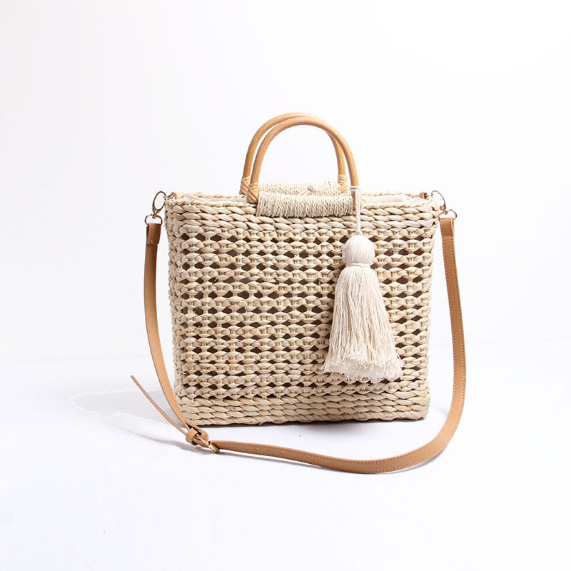 Handcrafted straw shoulder bag with decorative tassel pendant Stornfield