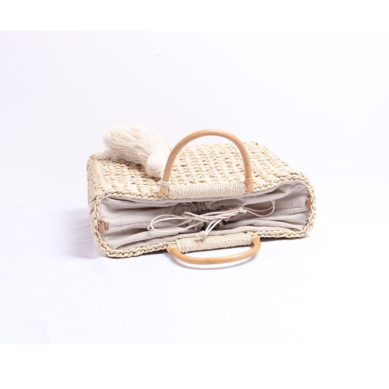 Handcrafted straw shoulder bag with decorative tassel pendant Stornfield