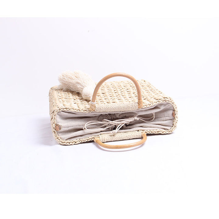 Handcrafted straw shoulder bag with decorative tassel pendant Stornfield