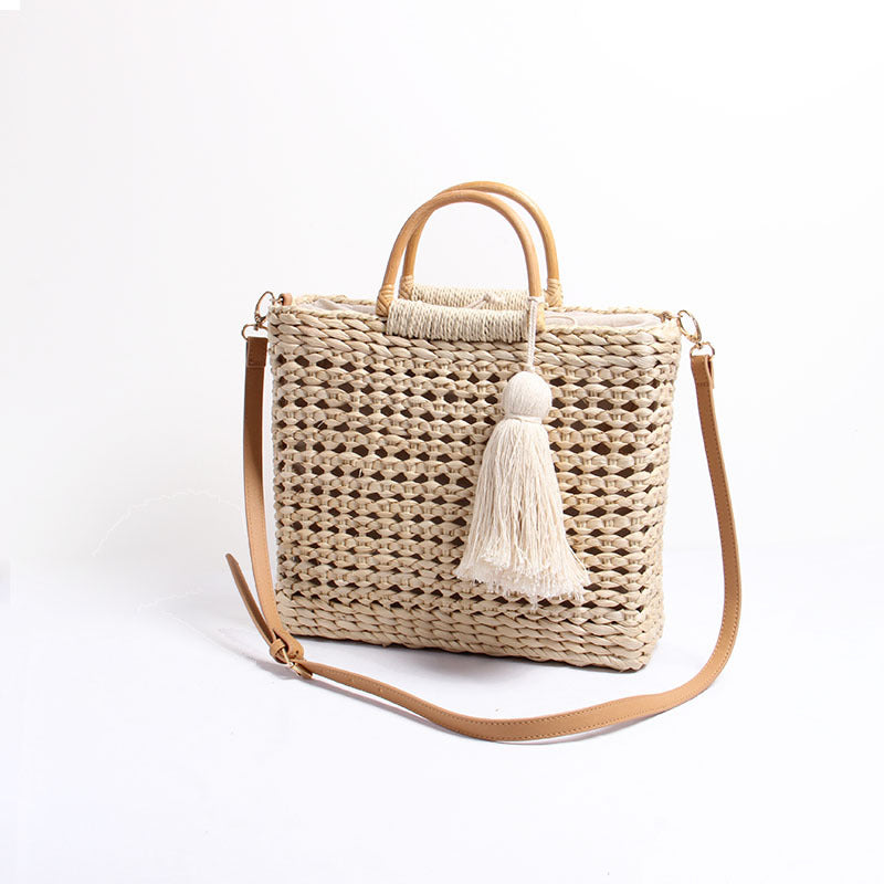 Handcrafted straw shoulder bag with decorative tassel pendant Stornfield