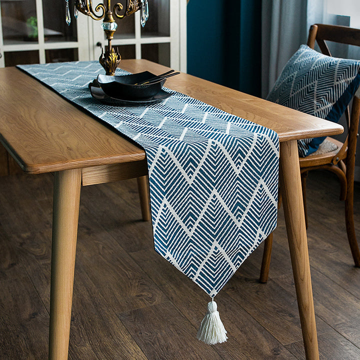 More modern woven table runner made of cotton blend with chevron jacquard and tassels