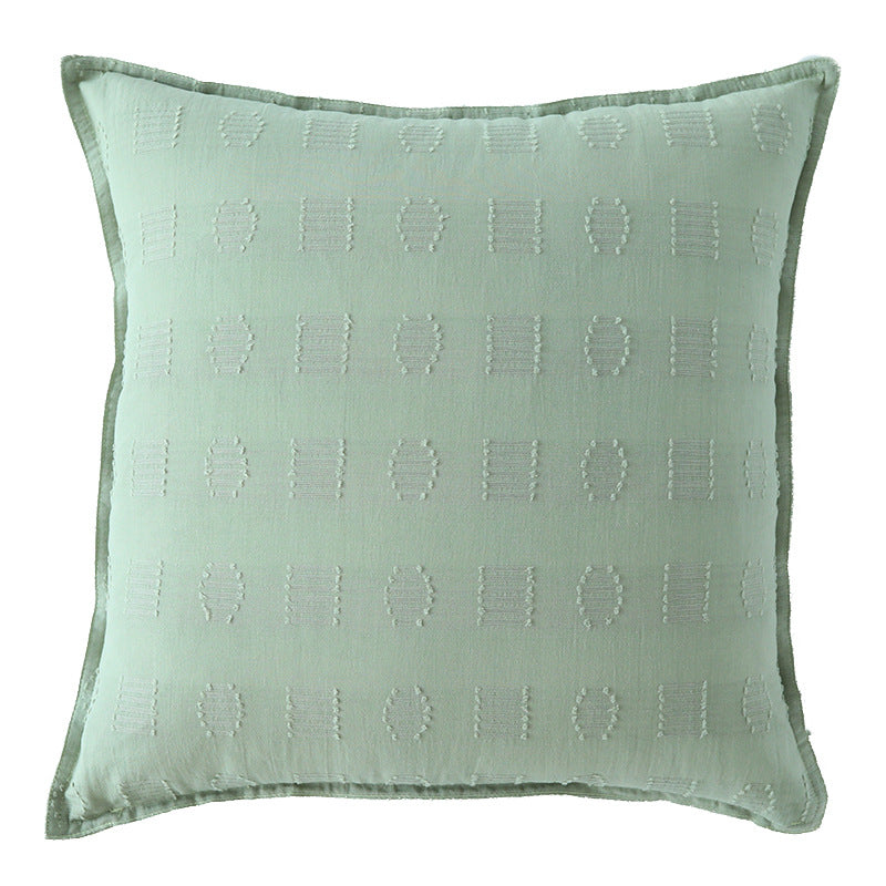 Square decorative cushion cover with subtle tufted geometric relief and piping