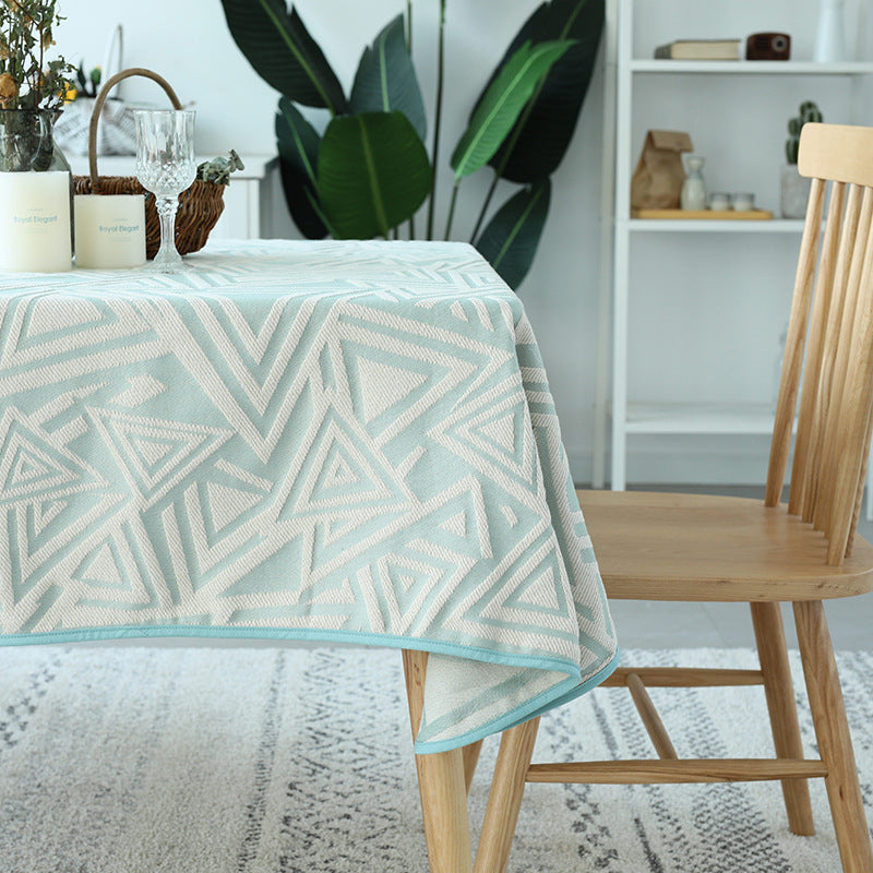 Woven jacquard tablecloth with geometric triangle pattern and easy-care cotton blend
