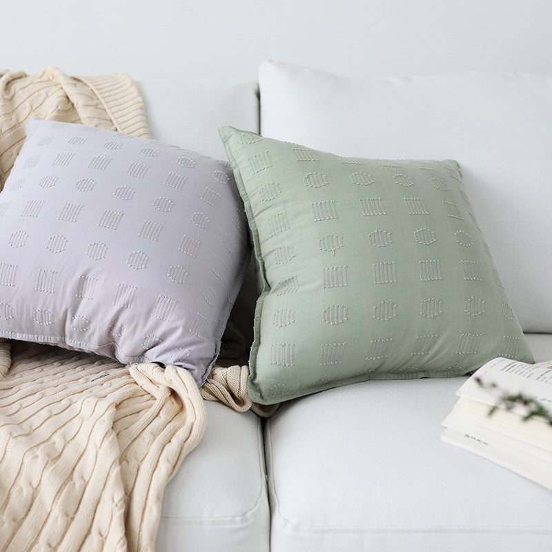 Square decorative cushion cover with subtle tufted geometric relief and piping