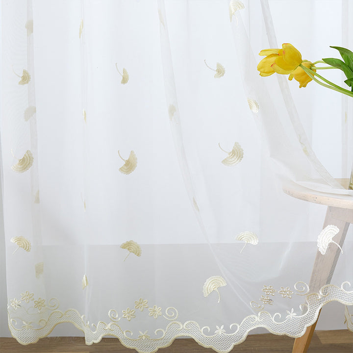Transparent curtain drape made of fine tulle with embroidered ginkgo leaves and curved lace finish Stornfield