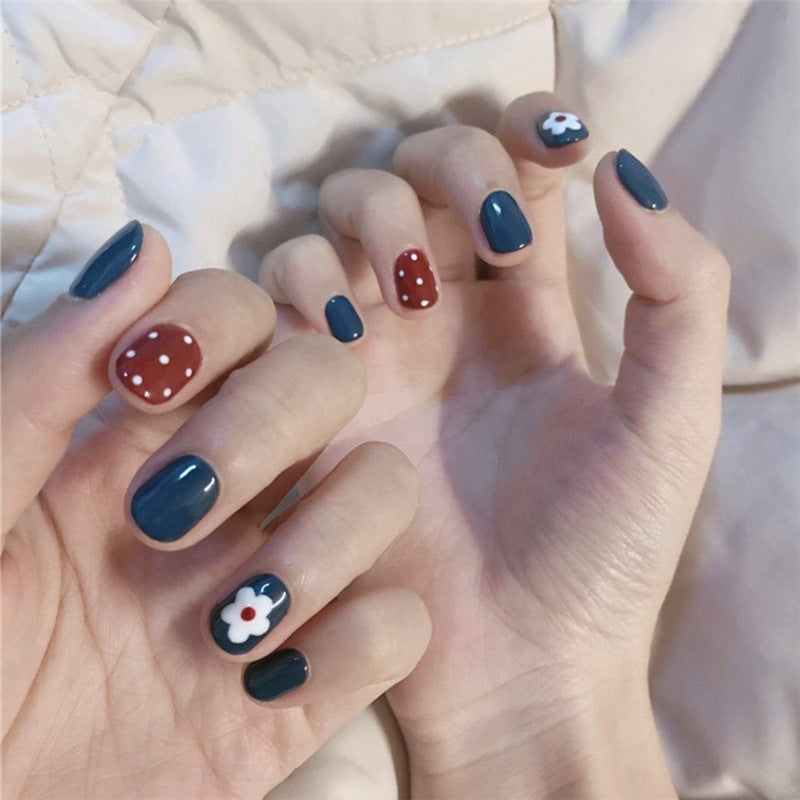 Artificial nails in a creative design with floral accents Stornfield