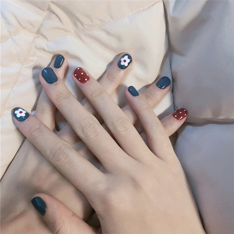 Artificial nails in a creative design with floral accents Stornfield