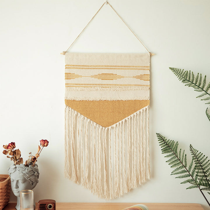 Handwoven wall hanging made of cotton blend with layered textures, wood rod and long fringes Stornfield