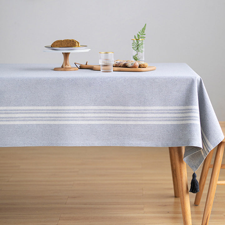 Rectangular linen look tablecloth with fringed tassels and side stripe border design Stornfield