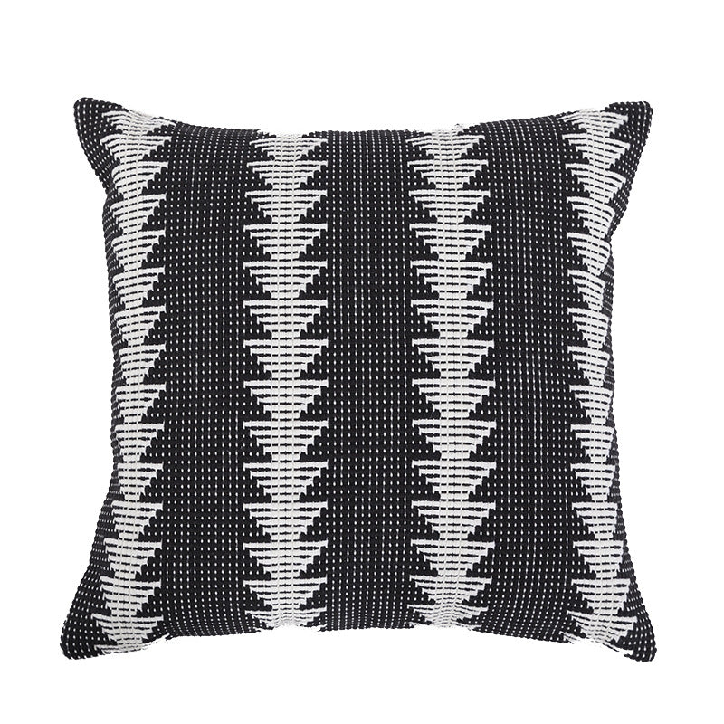 Square woven decorative cushion cover in tribal jacquard with pom-pom corners