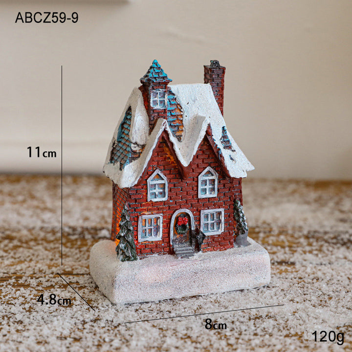 Illuminated Christmas house made of resin for table decoration
