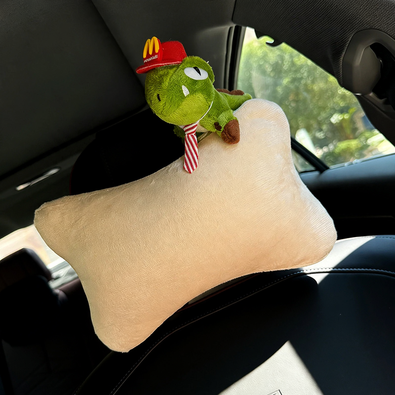 Car headrest with dinosaur design