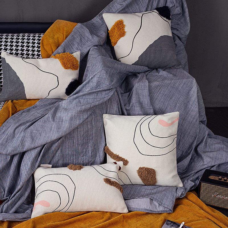 Woven decorative cushion cover in an abstract-minimalist Scandi look with hand-tufted applications
