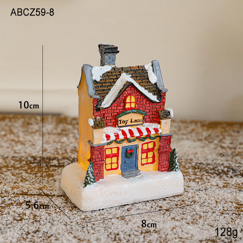 Illuminated Christmas house made of resin for table decoration