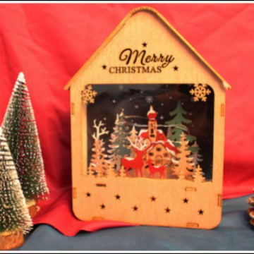 Illuminated wooden house with Christmas motif