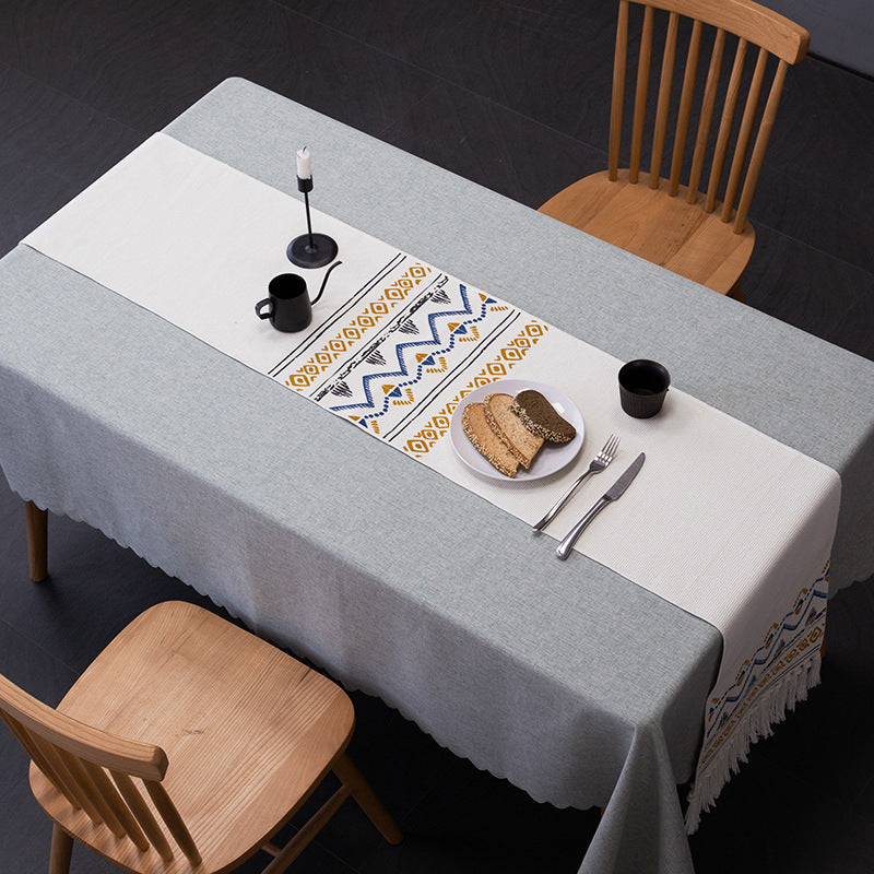 Woven table runner with fringes and ethnic chevron pattern