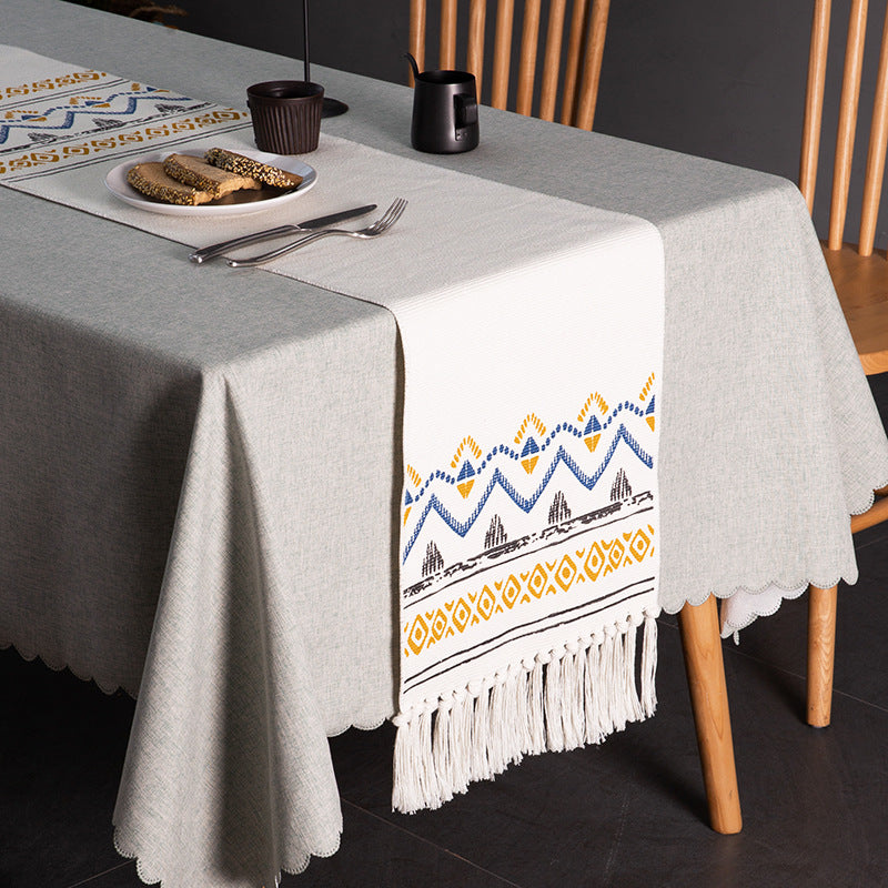 Woven table runner with fringes and ethnic chevron pattern