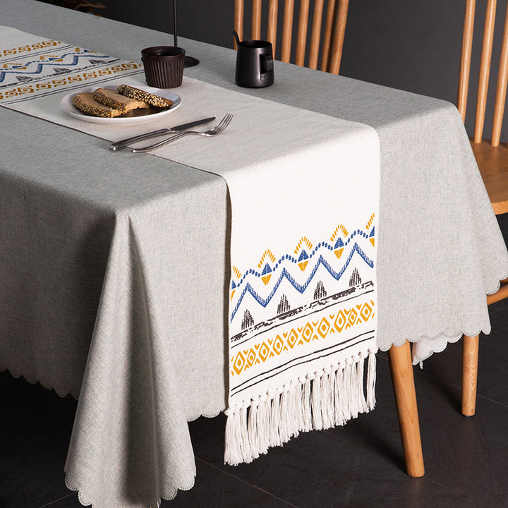 Woven table runner with fringes and ethnic chevron pattern
