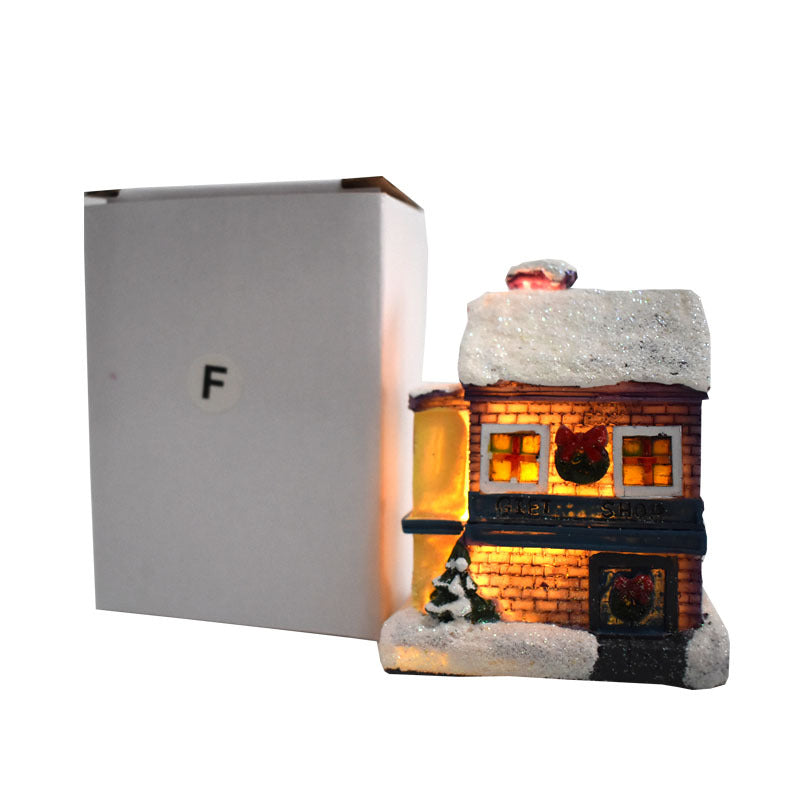 Illuminated Christmas house made of resin with snow effect