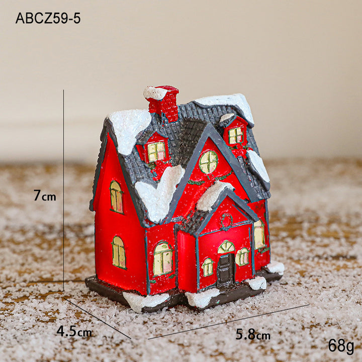 Illuminated Christmas house made of resin for table decoration