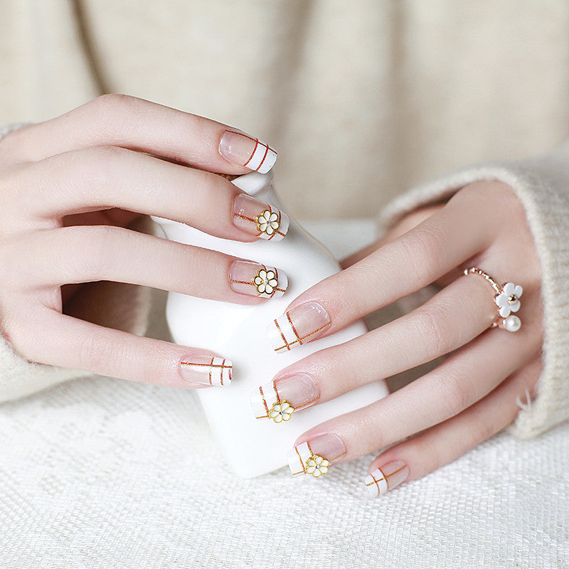 Artificial nails with elegant 3D flower accents and gold trim Stornfield
