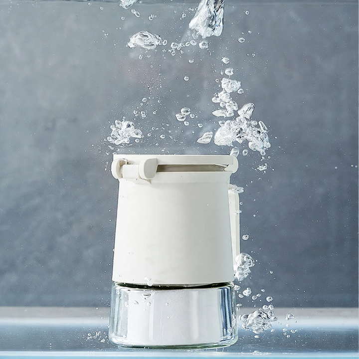 Sealed spice container made of glass with spoon