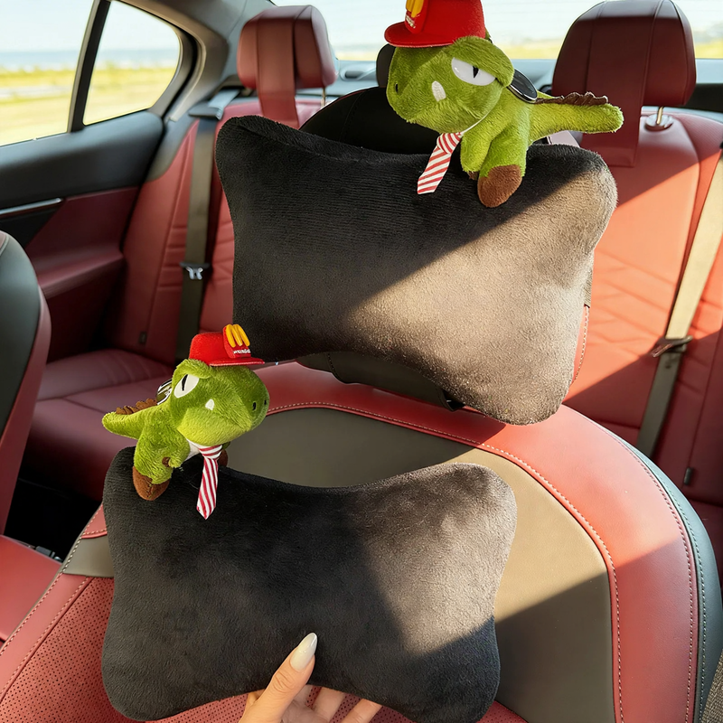 Car headrest with dinosaur design