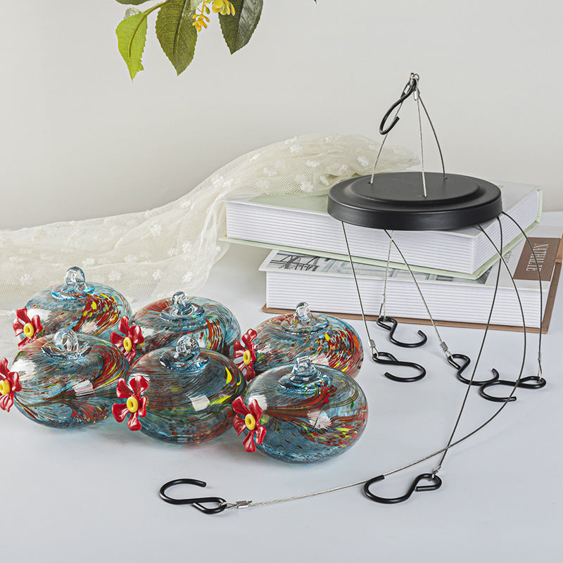 Hanging bird feeder and water station made of glass