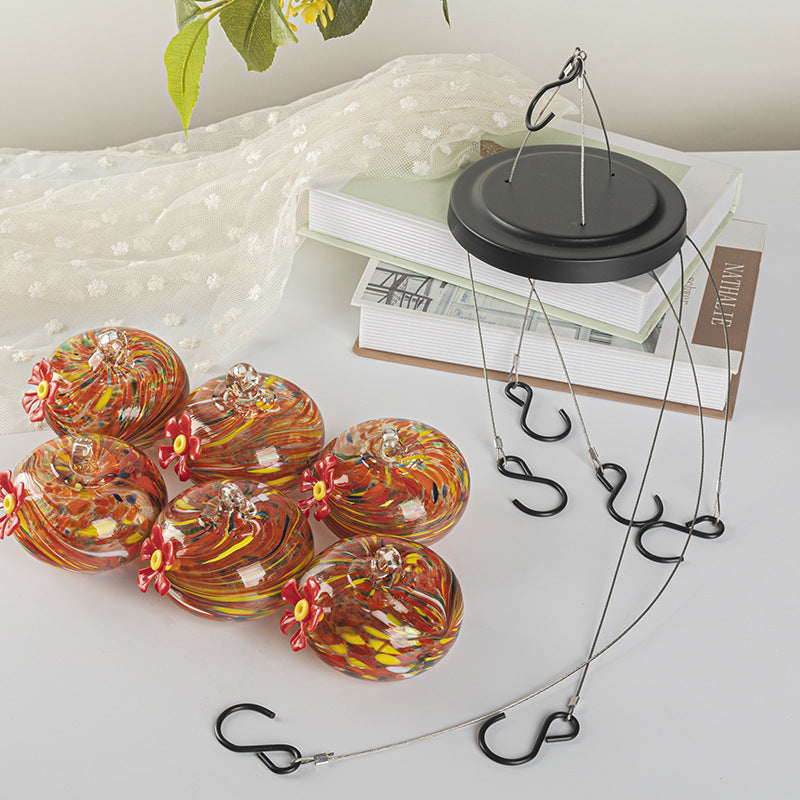 Hanging bird feeder and water station made of glass
