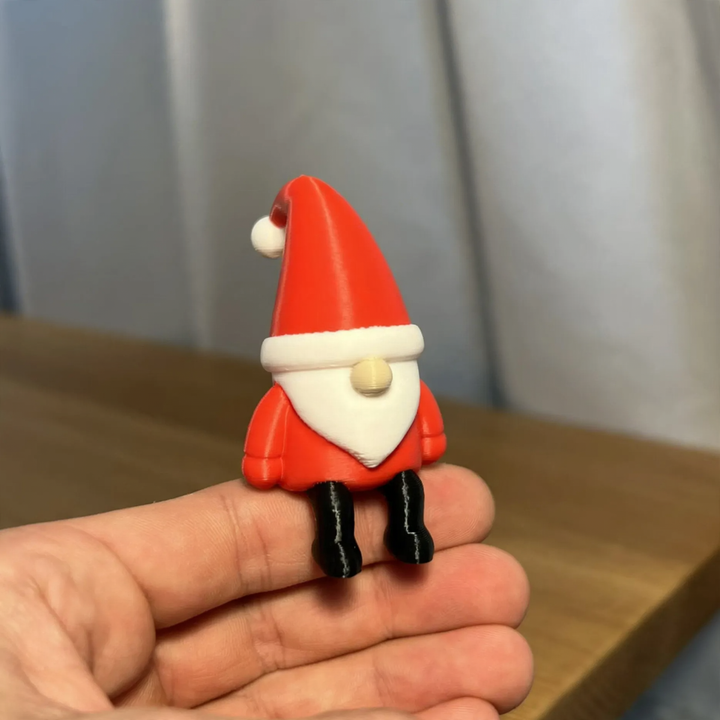 Miniature Santa Claus figure, sitting
