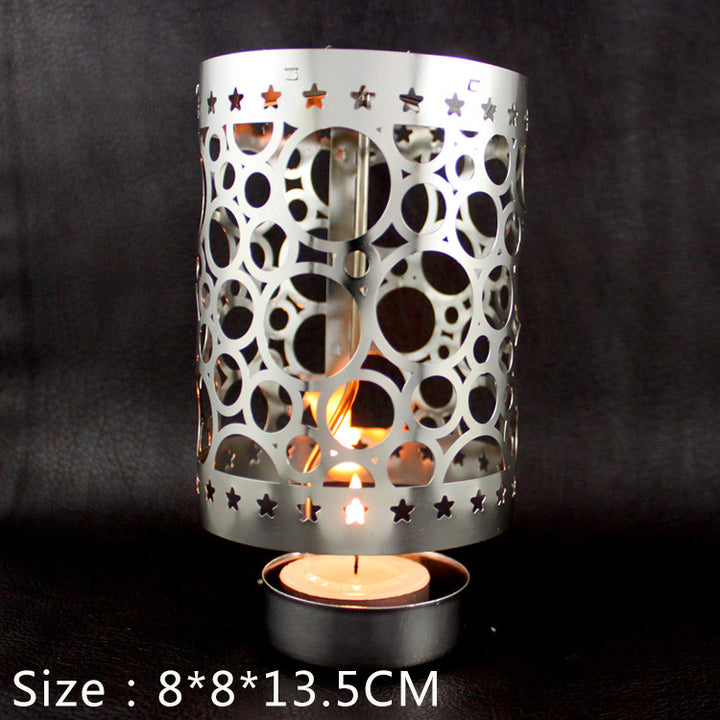 Rotating tea light holder made of brass, openwork design