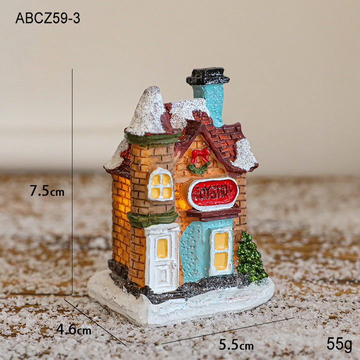 Illuminated Christmas house made of resin for table decoration