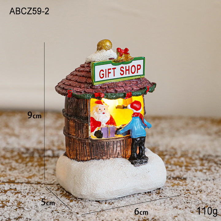 Illuminated Christmas house made of resin for table decoration