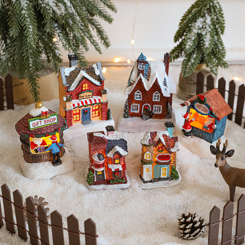 Illuminated Christmas house made of resin for table decoration