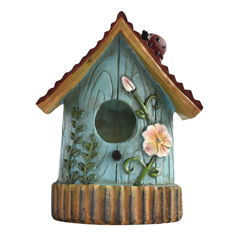 Decorative birdhouse made of resin for the wall