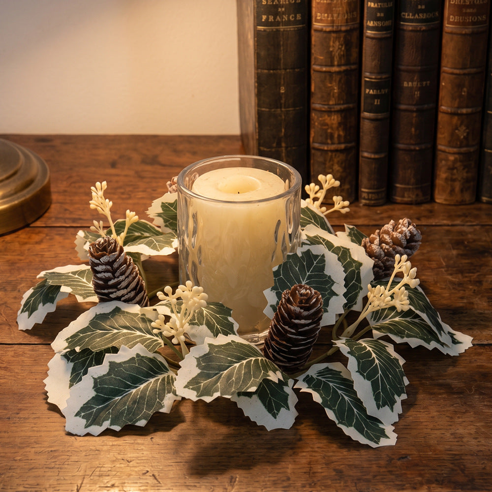 Christmas candle wreath with holly and pine cones