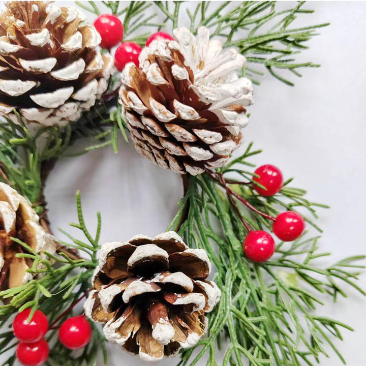 Christmas candle wreath with pine needles and berries