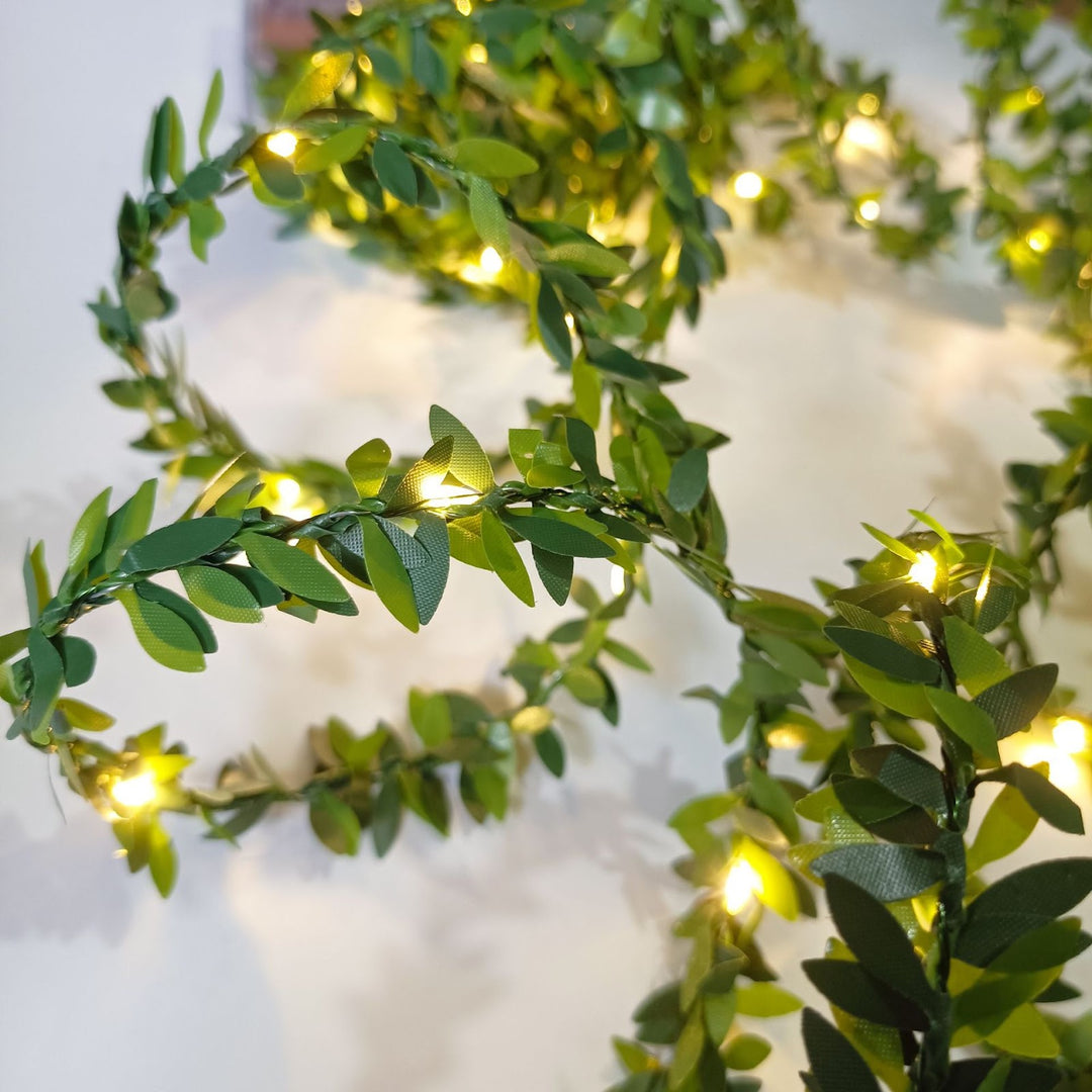 LED light chain with artificial leaves