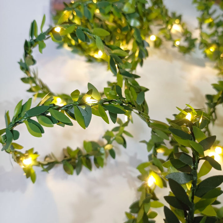 LED light chain with artificial leaves