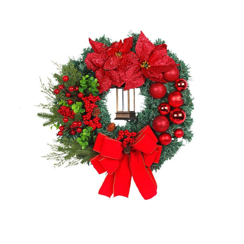 Christmas wreath with decorative lantern and red flowers