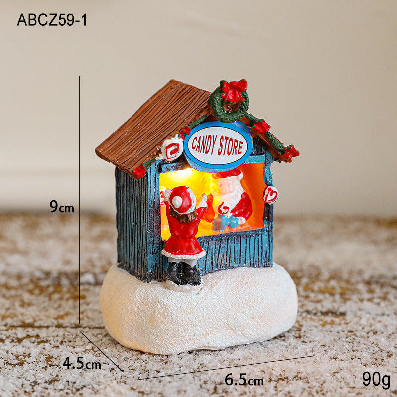 Illuminated Christmas house made of resin for table decoration