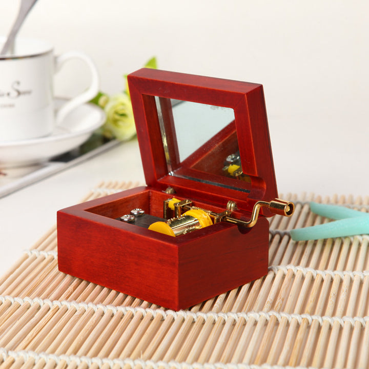 Wooden music box with hand crank