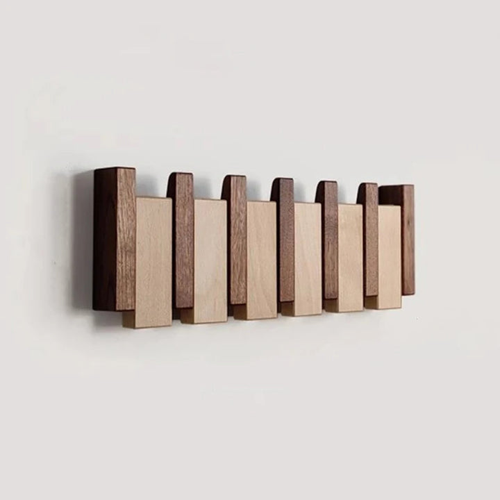Wooden coat rack in piano design with foldable hooks | Stornfield