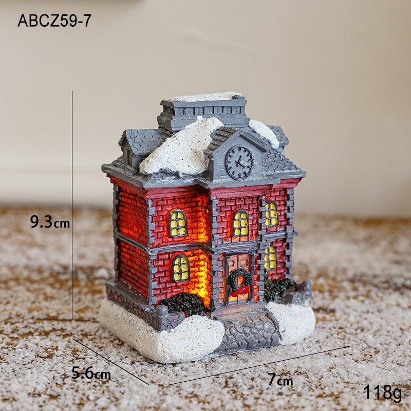 Illuminated Christmas house made of resin for table decoration
