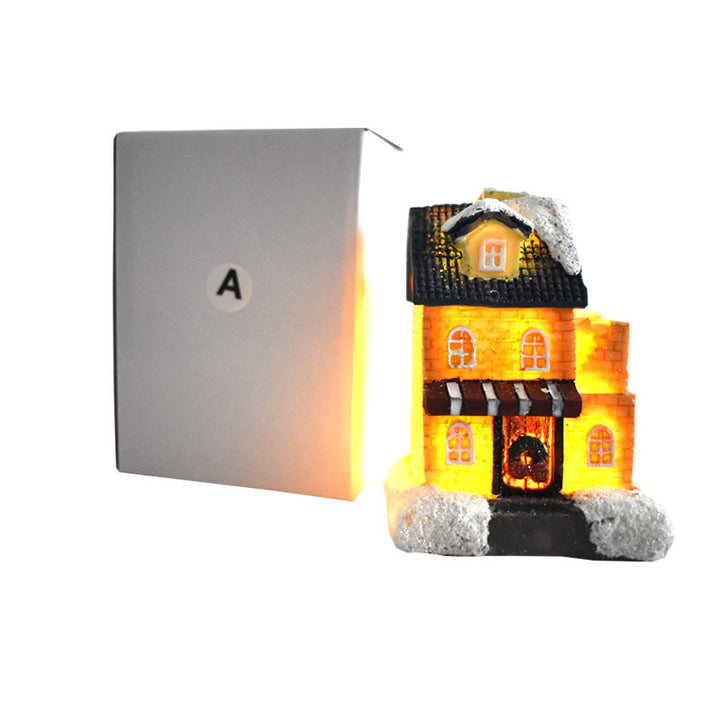 Illuminated Christmas house made of resin with snow effect