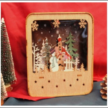 Illuminated wooden house with Christmas motif
