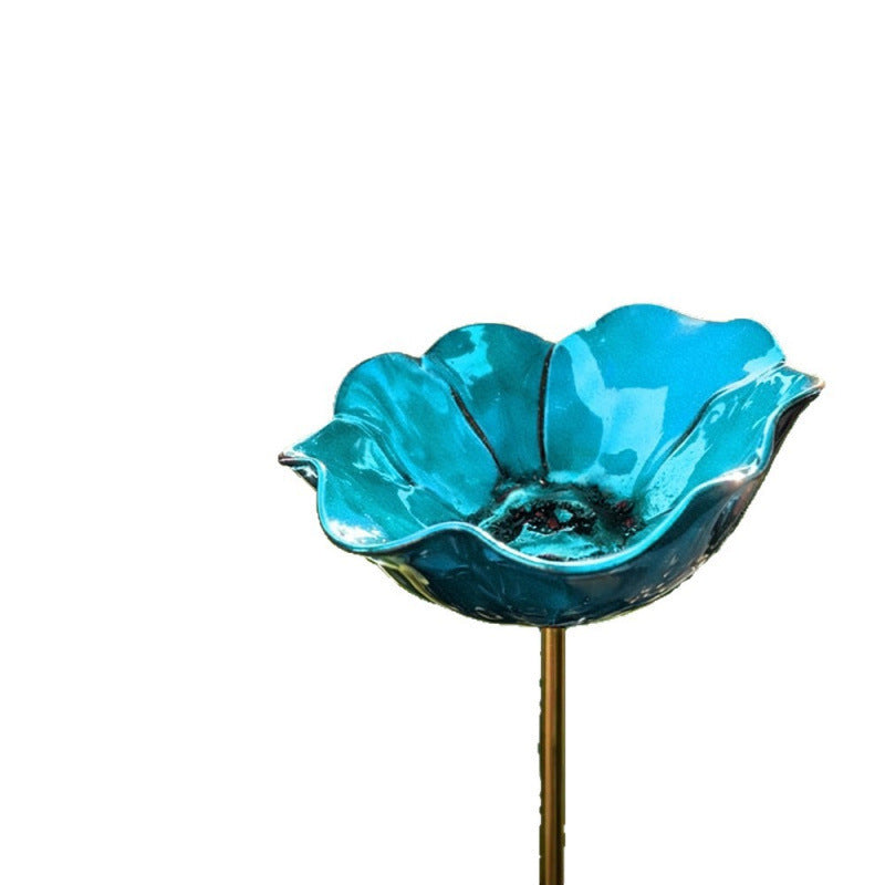 Decorative bird feeder made of metal in flower shape